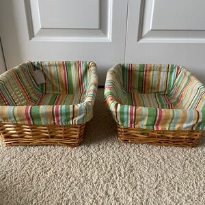 Two brown wicker baskets Cocalo collection. With striped fitted inserts